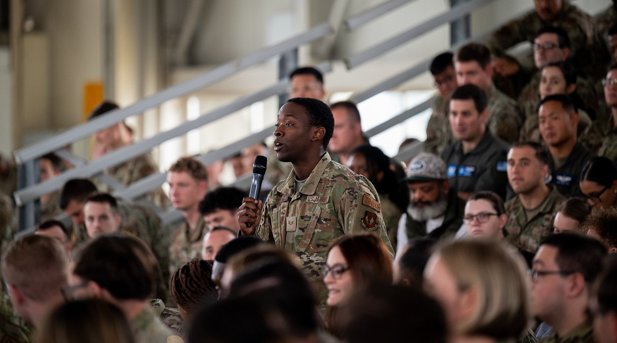 Airman asks a question to leadership during all call