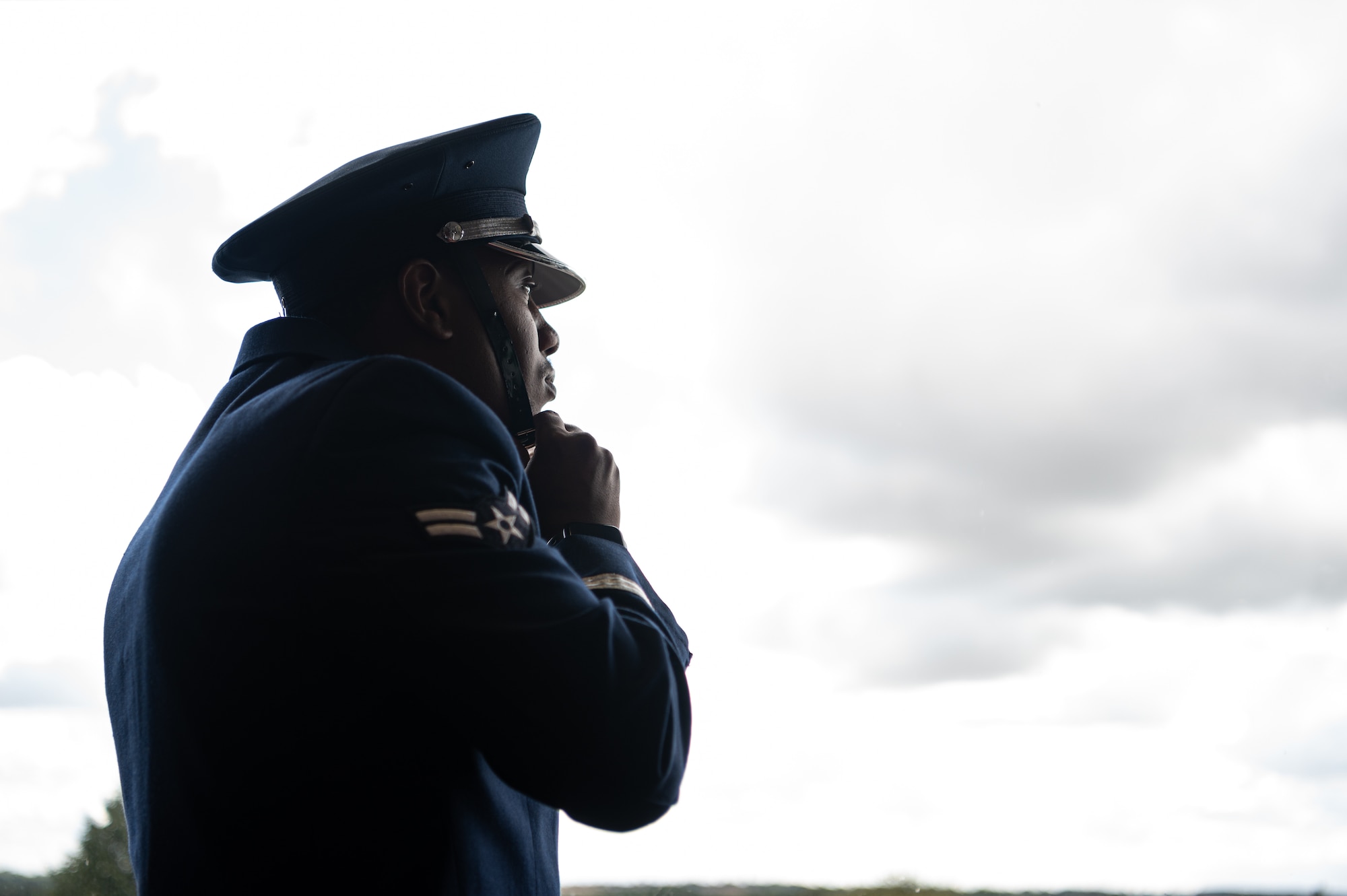 U.S. Air Force Airman 1st Class Tyreq Upshaw, Royal Air Force Mildenhall honor guardsman, fastens his cap before a ceremony at the USA Snetterton 300 race in Norfolk, England, Sept. 8, 2024.