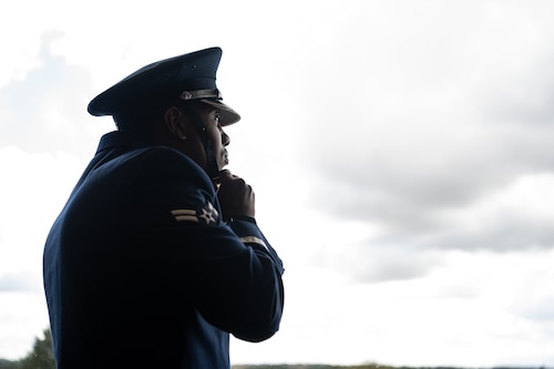 U.S. Air Force Airman 1st Class Tyreq Upshaw, Royal Air Force Mildenhall honor guardsman, fastens his cap before a ceremony at the USA Snetterton 300 race in Norfolk, England, Sept. 8, 2024.