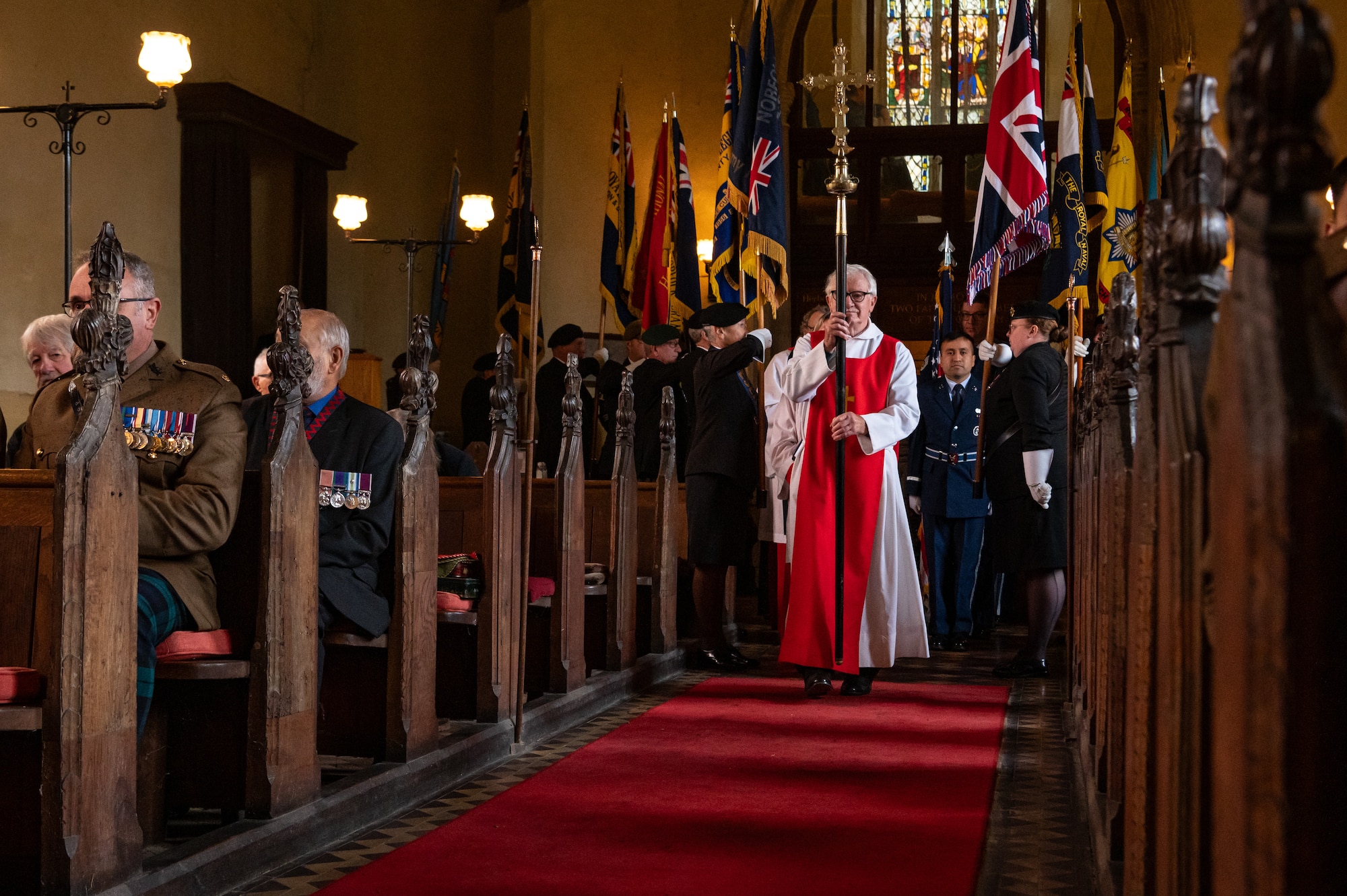 Members of the St. Andrews Church, U.S. Airmen, and U.K. military members walk down the aisle as part of a service commemorating the Battle of El Alamein in Honingham Norfolk, England, Oct. 20, 2024.
