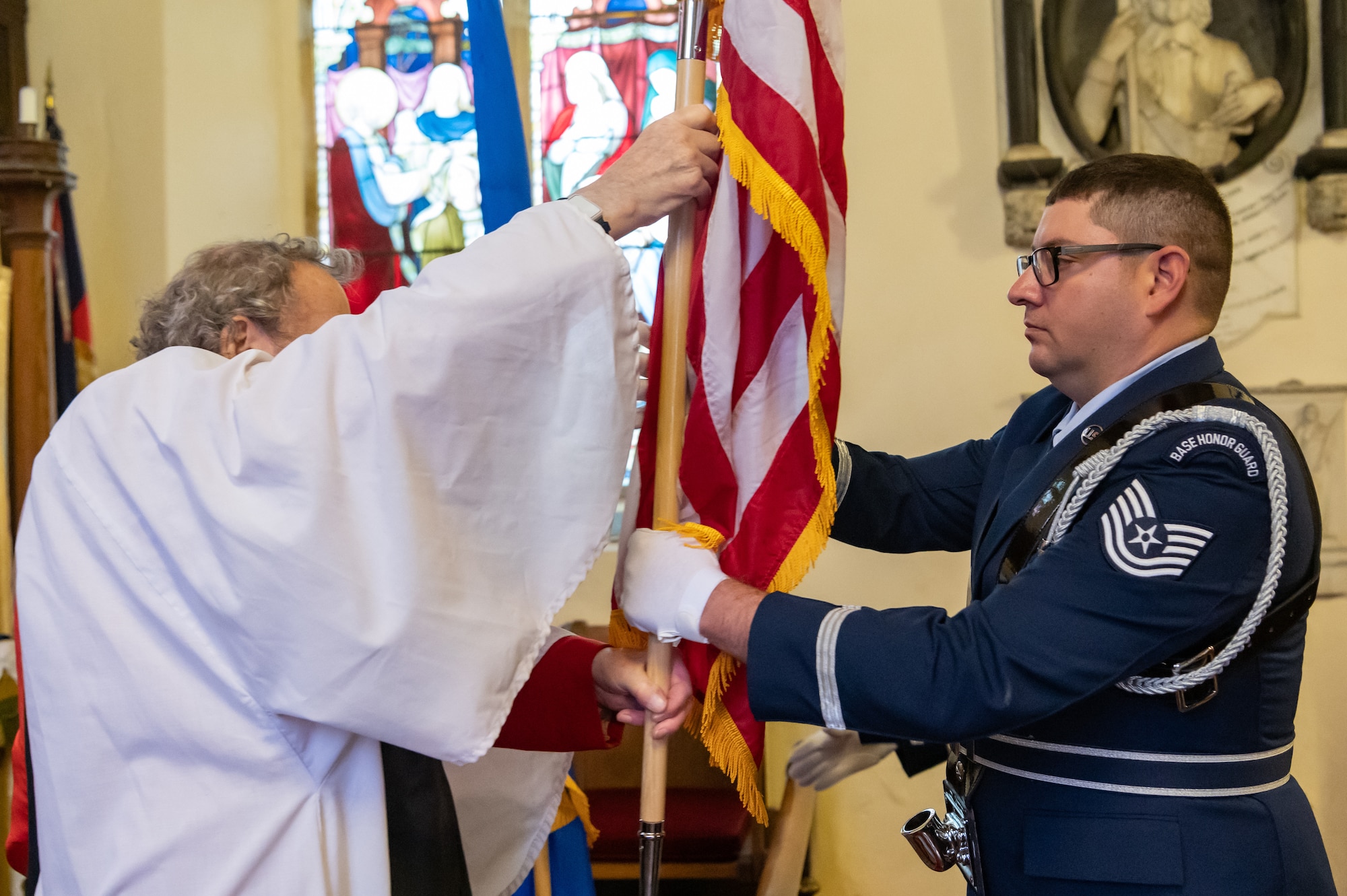 U.S. Air Force Tech. Sgt. William Knoche, Royal Air Force Mildenhall Honor Guardsman, receives the U.S. flag from a member of the St. Andrews Church, Honingham Norfolk, England, Oct. 20, 2024.