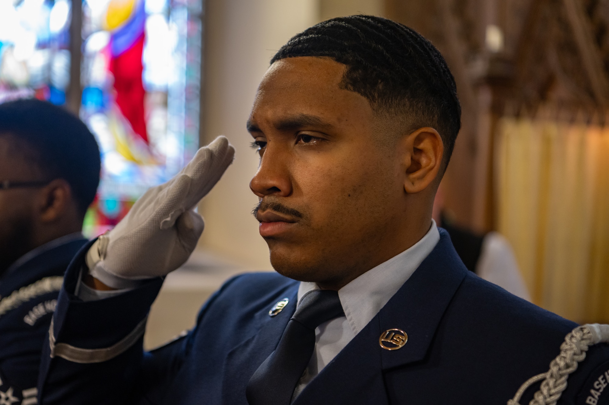 U.S. Air Force Staff Sgt. Devaundre Carmona, Royal Air Force Mildenhall Honor Guardsman, salutes during the playing of the U.K. national anthem at the St. Andrews Church, Honingham Norfolk, England, Oct. 20, 2024.