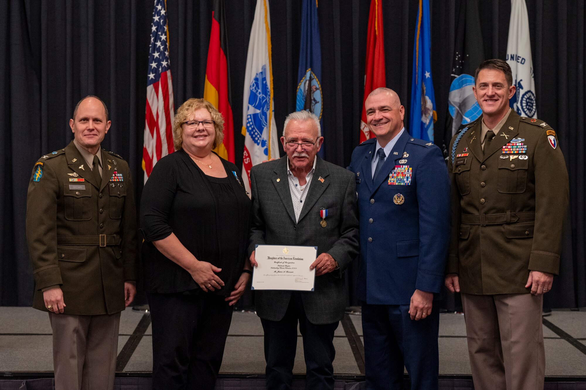 James Barranle, center, is recognized as the Daughters of the American Revolution 2024 outstanding veteran volunteer during the 2024 Military Retiree Appreciation Day event at Ramstein Air Base, Germany, Oct. 21, 2024.