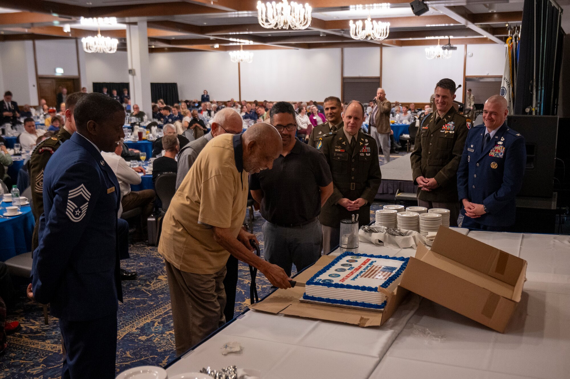 The youngest and oldest retirees at the 2024 Military Retiree Appreciation Day event cut a cake at Ramstein Air Base, Germany, Oct. 21, 2024.
