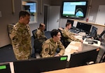 U.S. Airmen assigned to the 126th Intelligence Squadron support and train Airmen and Guardians of the 213th Space Warning Squadron at Clear Space Force Station, Alaska, June 21, 2024, as part of the Polar Surge partnership. The joint effort between the 178th Wing and 213th provides space surveillance data to the NORAD Space Control Center.