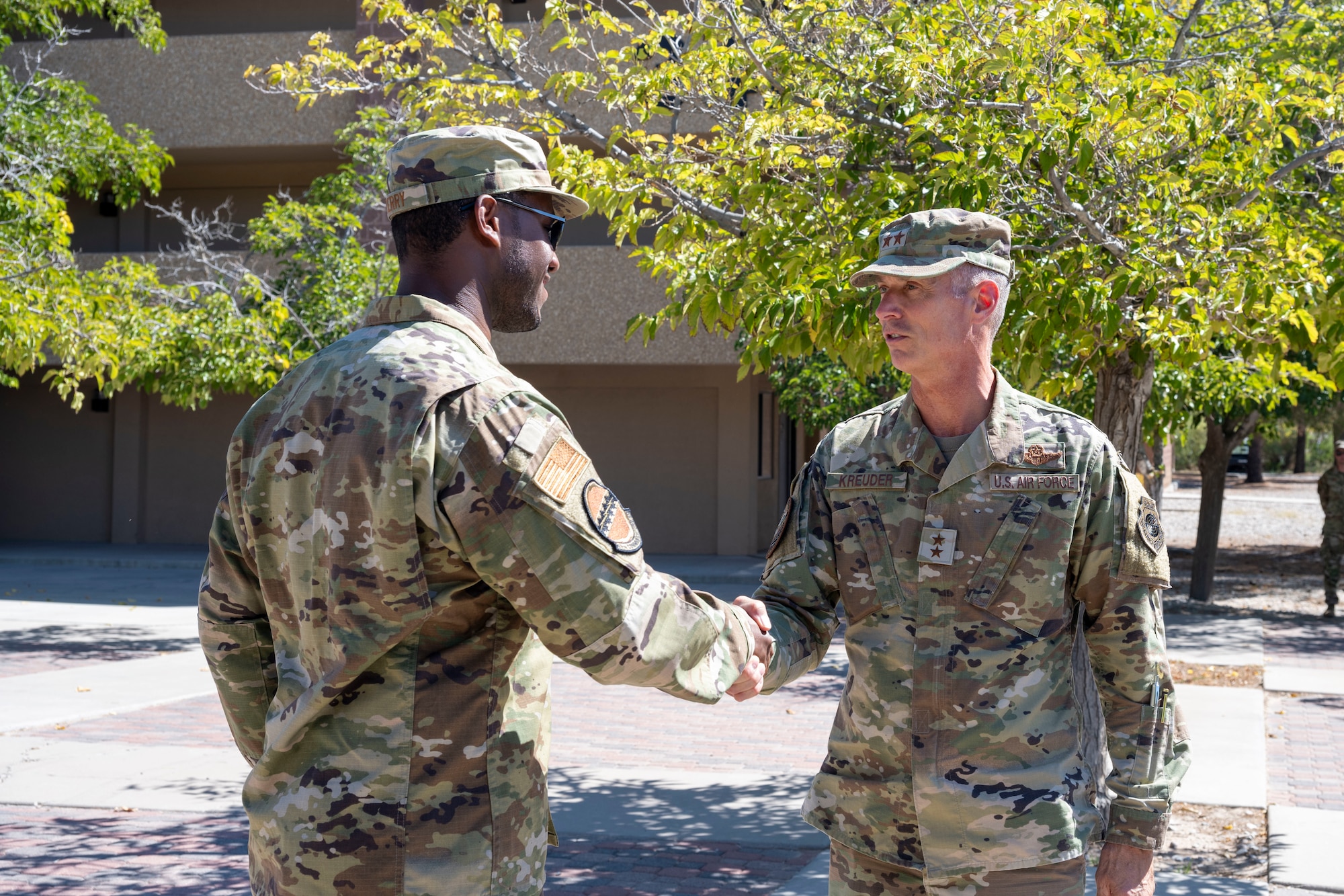 U.S. Air Force Maj. Gen. Gregory Kreuder, 19th Air Force commander, right, coins U.S. Air Force Tech. Sgt. Dre Perry, 49th Communications Squadron base equipment custodian at Holloman Air Force Base, New Mexico, Oct. 8, 2024. The 19th Air Force Command Team visited Holloman Air Force Base to evaluate the installation's capabilities, identify areas for improvement, and explore how the 19th AF can enhance support for the installation. (U.S Air Force photo by Senior Airman Isaiah Pedrazzini)