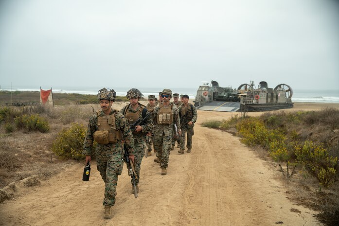 Marines assigned to 15th Marine Expeditionary Unit, walk towards a staging area after disembarking a U.S. Navy Landing Craft, Air Cushion 27, aboard Marine Corps Base Camp Pendleton, California, Oct. 16, 2024. Elements of the 15th MEU embarked aboard amphibious dock landing ship USS Harpers Ferry (LSD 49), returned to Marine Corps Base Camp Pendleton after a seven-month deployment to the Indo-Pacific region in support of regional stability and a free and open Indo-Pacific.