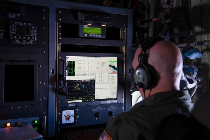 Lt. Col. Tobi Baker watches the computer during a test flight to ensure the new internet capability does not interfere with the aircraft mechanisms and software.