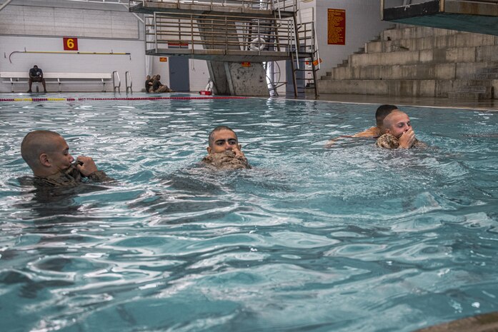 U.S. Marine Corps recruits with Kilo Company, 3rd Recruit Training Battalion, execute a float technique during a water survival class at Marine Corps Recruit Depot San Diego, California, Oct. 9, 2024. Recruits received basic water survival classes to prepare them for their swim qualification test. Basic water survival instructs recruits on how to execute basic water maneuvers and promotes combat readiness. (U.S. Marine Corps photo by Lance Cpl. Jacob B. Hutchinson)