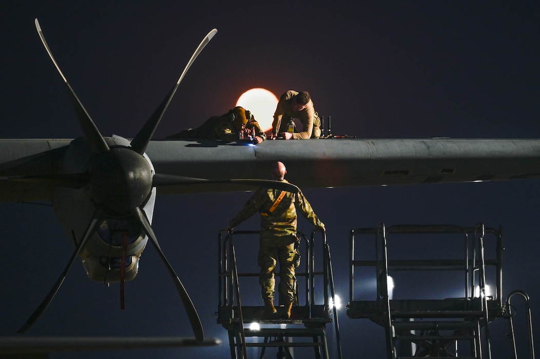 Team Little Rock Airmen perform maintenance on a C-130J Super Hercules while a Hunter's Moon rises over Little Rock Air Force Base, Arkansas, Oct. 17, 2024. This year’s Hunter’s Moon reached its peak illumination on Oct. 17, 2024, casting an especially bright glow due to its proximity to the autumnal equinox, making it one of the brightest full moons of the year.