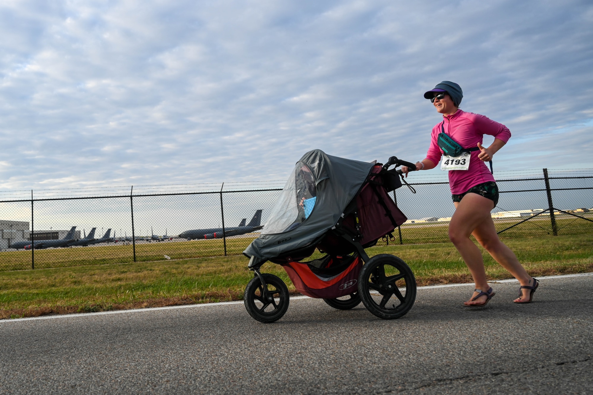 A base resident from the 22nd Air Refueling Wing runs with her stroller during the Tanker Trot Oct. 19, 2024, at McConnell Air Force Base, Kansas. The Tanker Trot is an annual event featuring both a 5K and 10K bringing together Airmen, their families and the local community to promote fitness and camaraderie. (U.S. Air Force photo by Senior Airman William Lunn)
