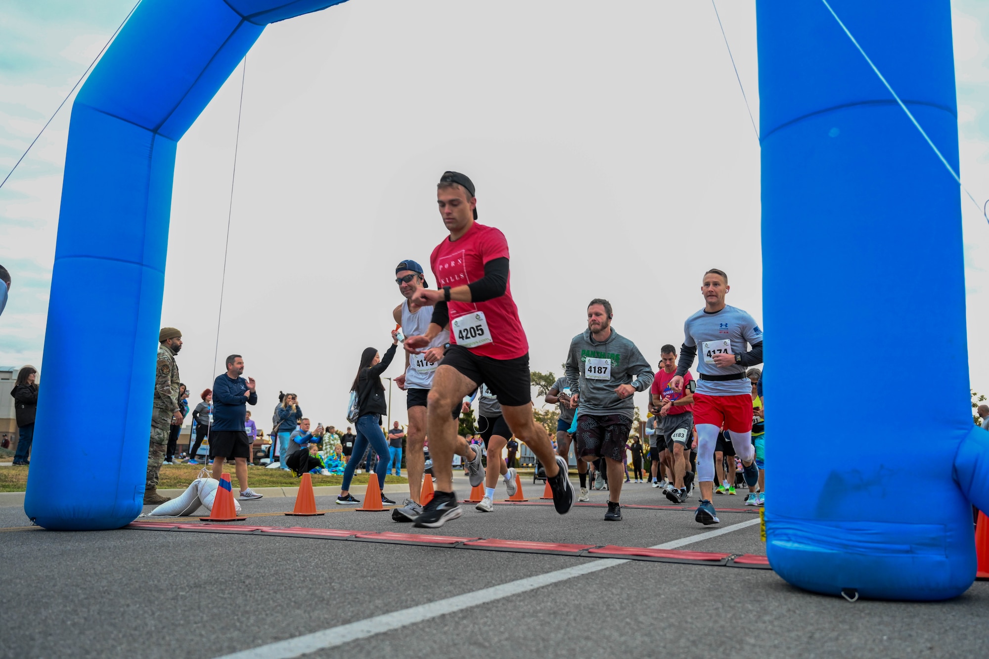 Airmen and base residents from the 22nd Air Refueling Wing run in the Tanker Trot Oct. 19, 2024, at McConnell Air Force Base, Kansas. The Tanker Trot is an annual event featuring both a 5K and 10K bringing together Airmen, their families and the local community to promote fitness and camaraderie. (U.S. Air Force photo by Senior Airman William Lunn)