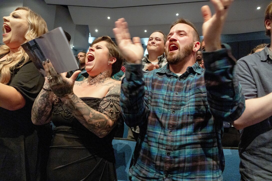 Shellby Norwood and Tyler Richards, both shipfitters, Shop 11, Shipfitters, cheer as classmates receive their certificates during the 2024 PSNS & IMF Apprentice Program graduation ceremony, Sept. 20, 2024, at Bremerton High School, in Bremerton, Washington. (U.S. Navy photo by Wendy Hallmark)
