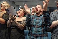 Shellby Norwood and Tyler Richards, both shipfitters, Shop 11, Shipfitters, cheer as classmates receive their certificates during the 2024 PSNS & IMF Apprentice Program graduation ceremony, Sept. 20, 2024, at Bremerton High School, in Bremerton, Washington. (U.S. Navy photo by Wendy Hallmark)
