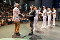 Kenyon Hall, tool maker, Shop 31, Inside Machinist, receives his certificate from Felicienne Griffin, Shop 31 trade superintendent, during the 2024 Puget Sound Naval Shipyard & Intermediate Maintenance Facility Apprentice Program graduation ceremony, Sept. 20, 2024, at Bremerton High School in Bremerton, Washington. (U.S. Navy photo by Wendy Hallmark)