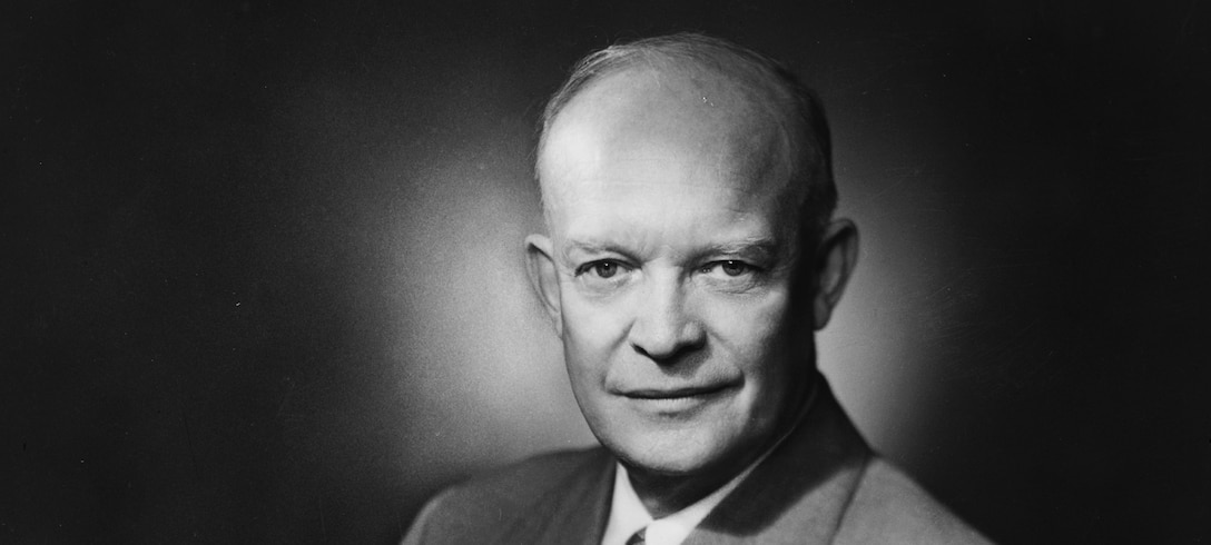 Dwight D. Eisenhower, three-quarter length portrait, seated, facing front.