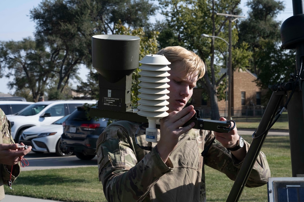 An Airman sets up a weather sensor