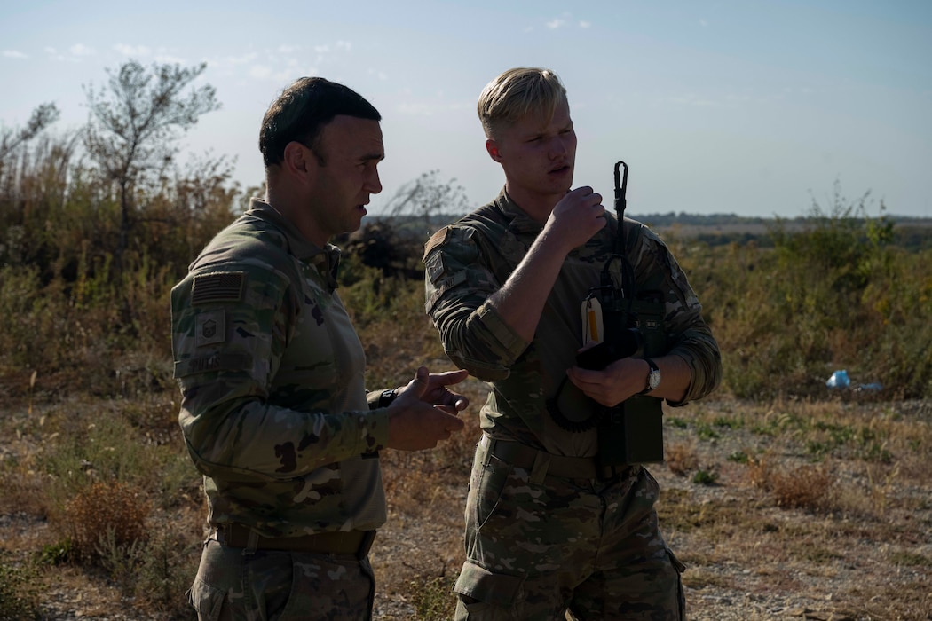 Airmen stand on a range