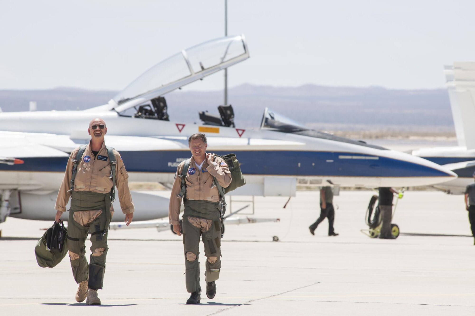 NASA pilots Nils Larson and Wayne Ringelberg head for a mission debrief after flying a NASA F/A-18 at Mach 1.38 to create sonic booms as part of the Sonic Booms in Atmospheric Turbulence flight series at NASA’s Armstrong Flight Research Center in California, to study sonic boom signatures with and without the element of atmospheric turbulence.