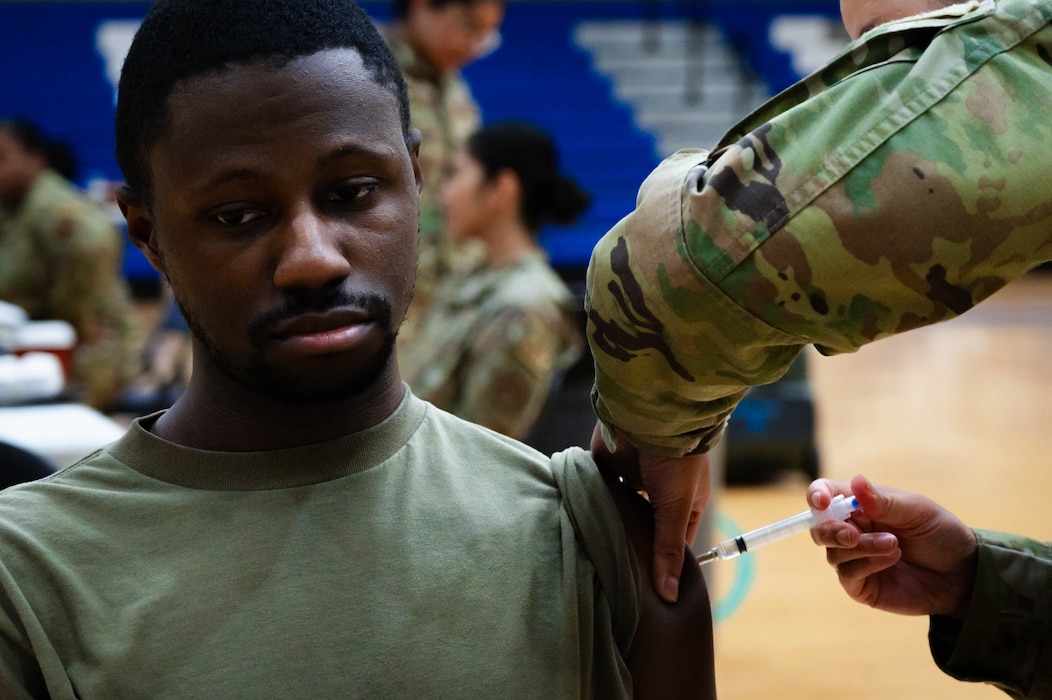 U.S. Air Force Airman 1st Class Bryson Bowie, 56th Operations Support Squadron air traffic control specialist, receives a flu vaccination.