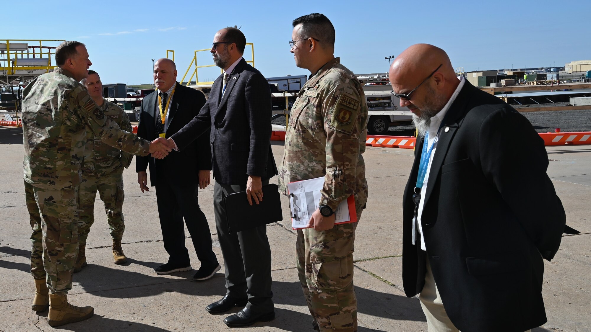 four men greeting one man