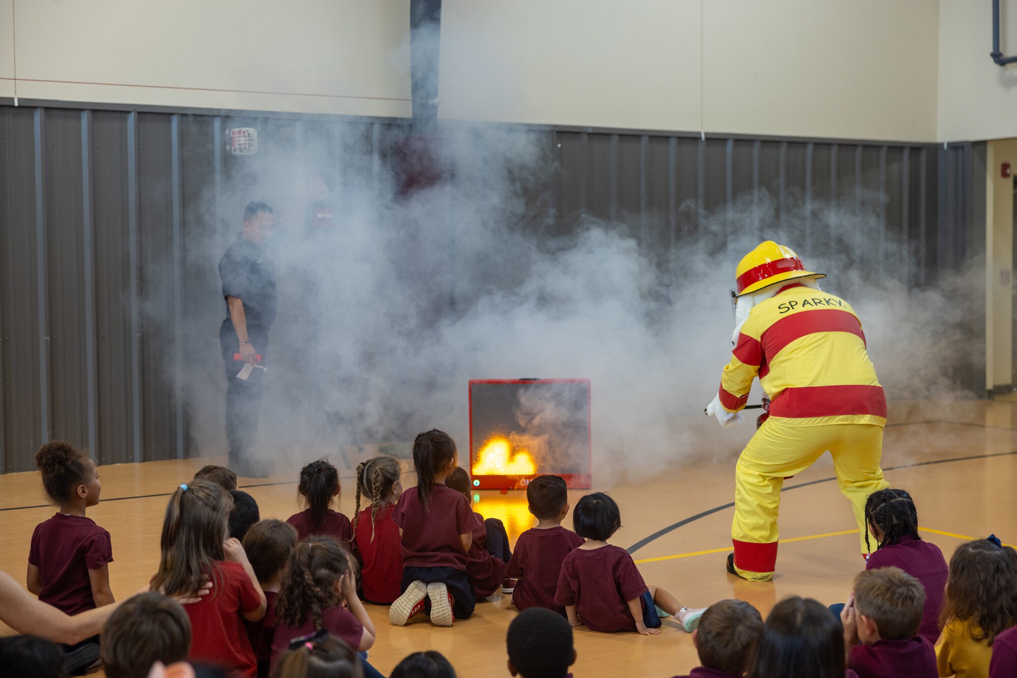 Sparky the fire dog demonstrates fire extinguisher