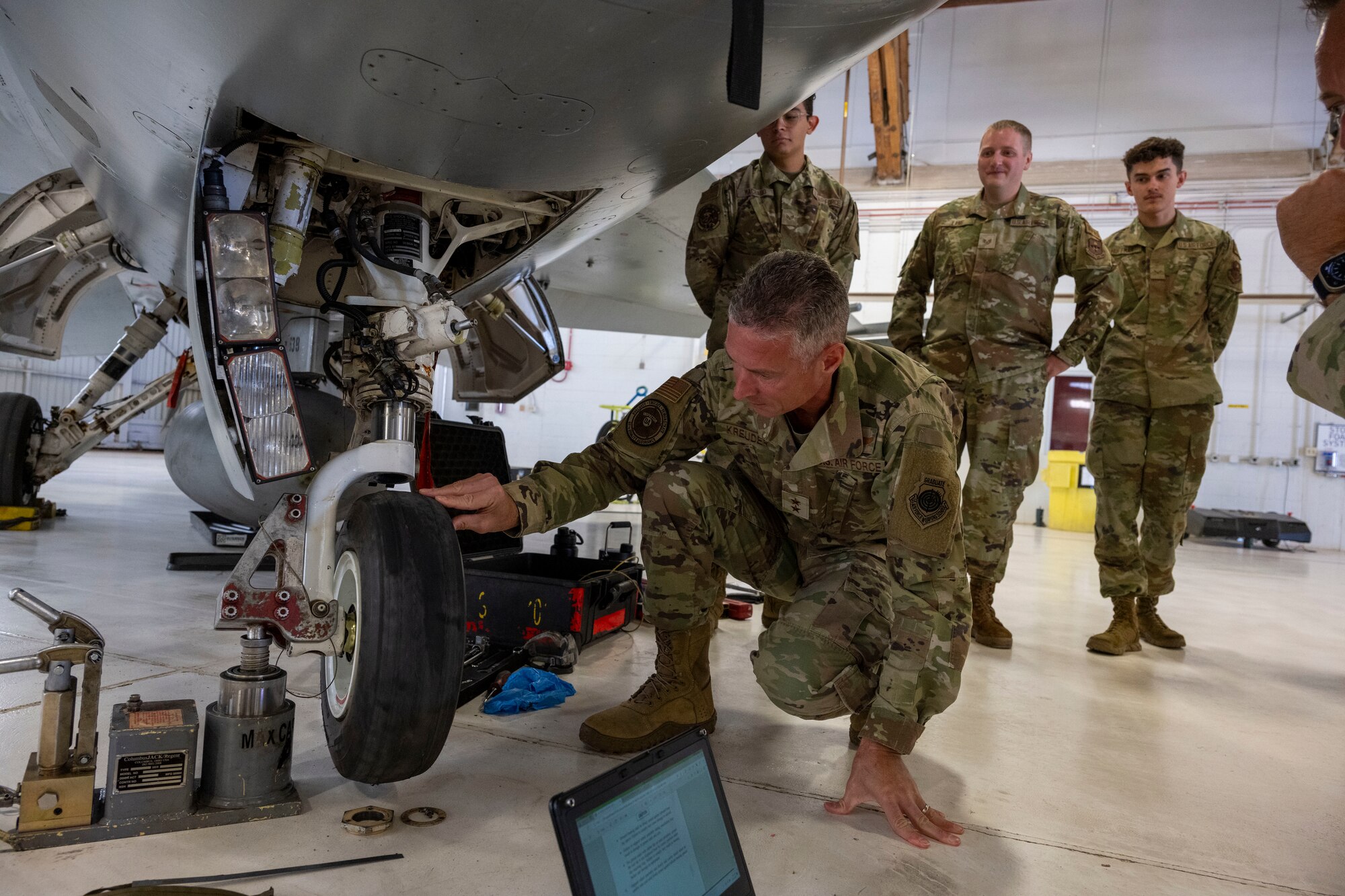 U.S. Air Force Maj. Gen. Gregory Kreuder, 19th Air Force commander, changes the tire of an F-16 Viper at Holloman Air Force Base, New Mexico, Oct. 8, 2024 Throughout the tour, Kreuder and U.S. Chief Master Sgt. Keith Scott, 19th Air Force command chief interacted with Airmen, observed squadron operations, and participated in various hands-on activities. (U.S Air Force photo by Senior Airman Isaiah Pedrazzini)