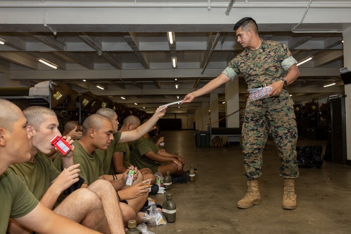 U.S. Marine Corps Staff Sgt. Arturo Del Toro, a drill instructor with Kilo Company, 3rd Recruit Training Battalion, hands out mail to recruits during senior drill instructor square away time at Marine Corps Recruit Depot San Diego, California, Oct. 8, 2024. SDI time is periodically scheduled to enable senior drill instructors to have the opportunity to address instructional remediation, core values reinforcement, mentorship, coaching and future training preparation. (U.S. Marine Corps photo by Lance Cpl. Janell B. Alvarez)