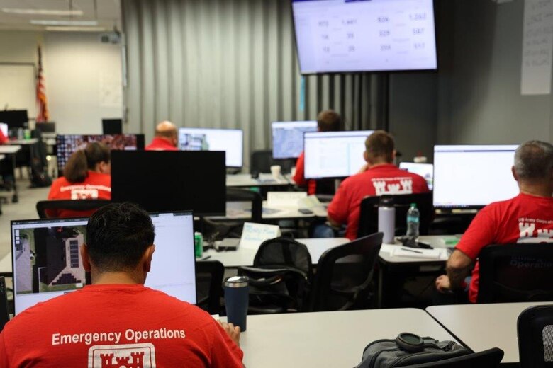People doing training on computers.