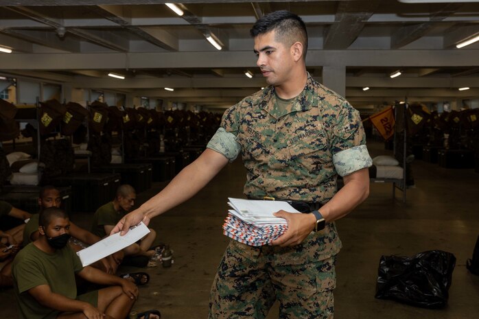 U.S. Marine Corps Staff Sgt. Arturo Del Toro, a senior drill instructor with Kilo Company, 3rd Recruit Training Battalion, hands out mail to recruits during senior drill instructor square away time at Marine Corps Recruit Depot San Diego, California, Oct. 8, 2024. SDI time is periodically scheduled to enable senior drill instructors to have the opportunity to address instructional remediation, core values reinforcement, mentorship, coaching and future training preparation. (U.S. Marine Corps photo by Lance Cpl. Janell B. Alvarez) (This photo has been altered for security purposes by blurring out addresses)
