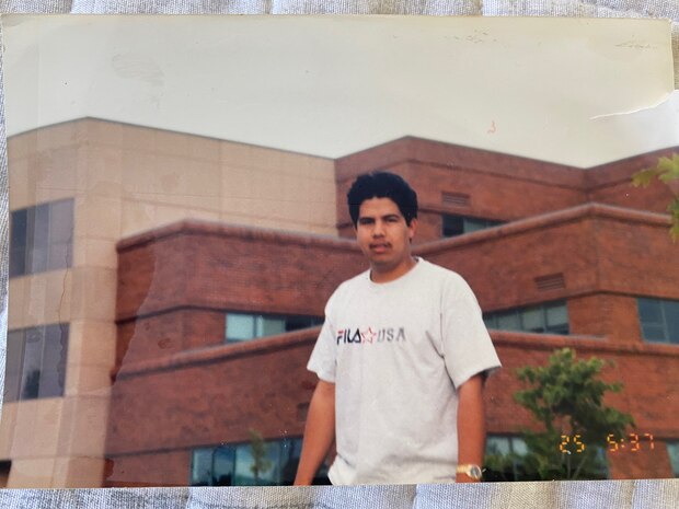 Juan Gaytan stands in front of the Walla Walla District building in Walla Walla, Washington, in 1999, shortly after arriving in the United States. Little did he know that he would one day work in this building.