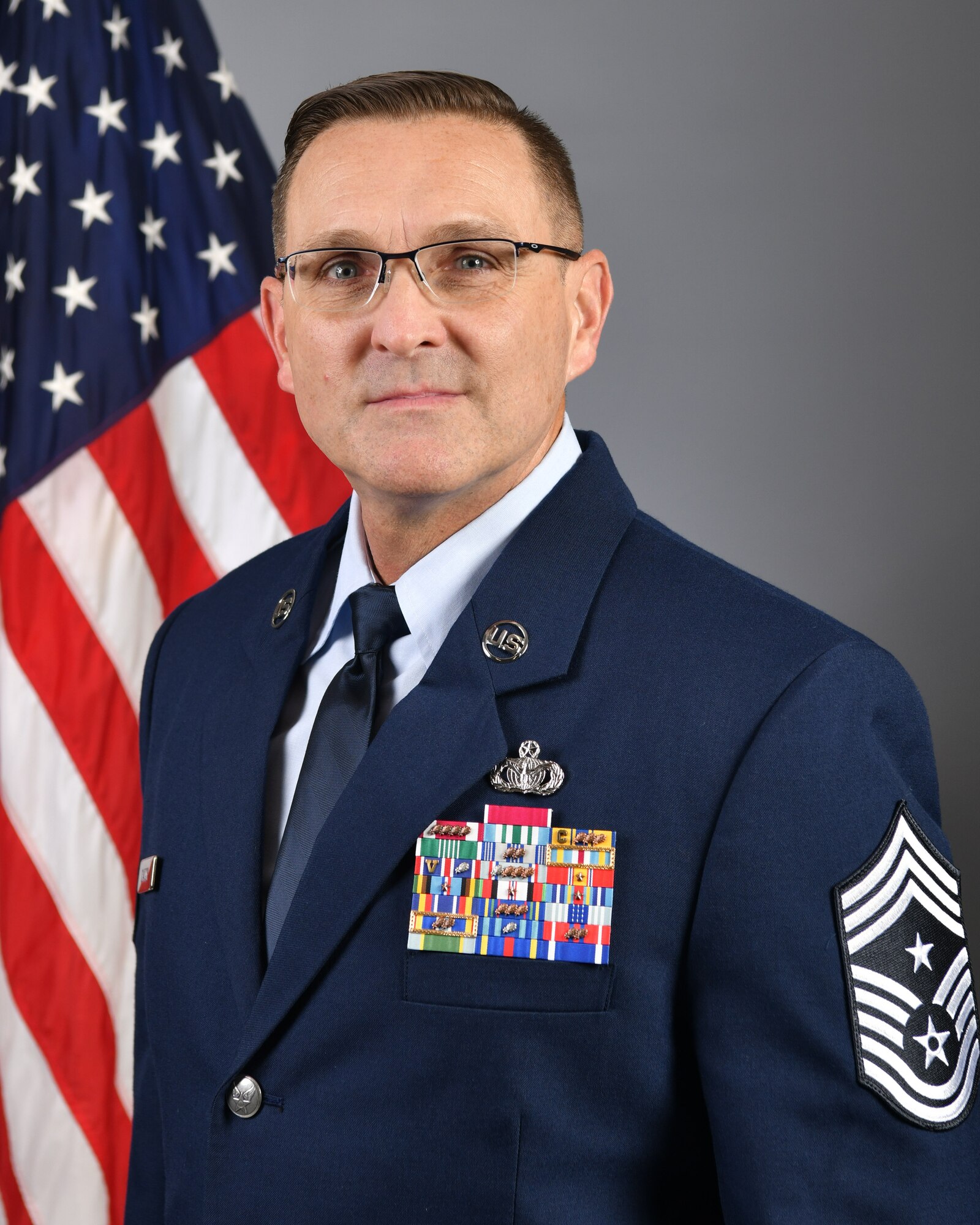 Man in uniform in front of U.S. flag