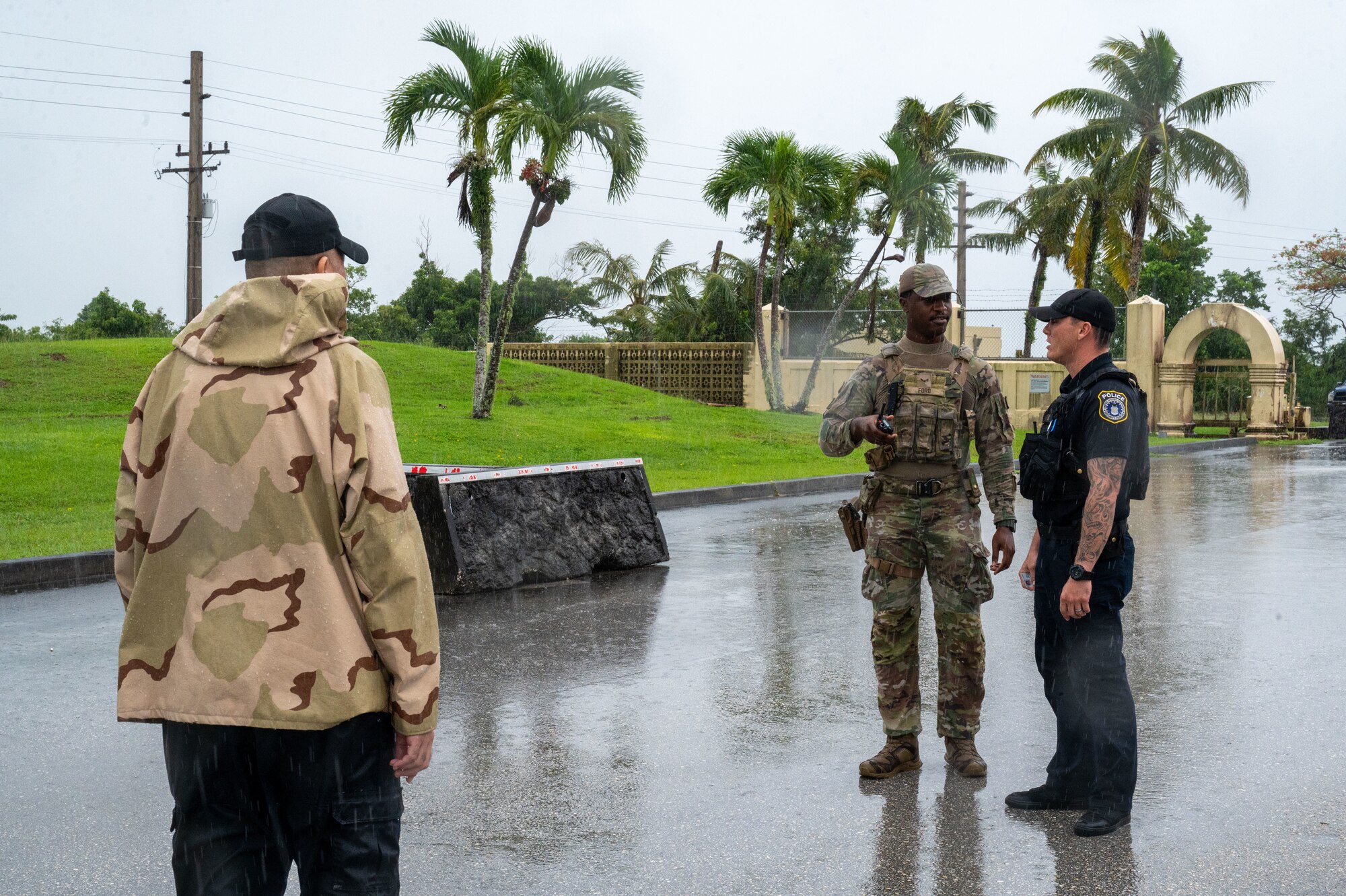 U.S. Air Force Airmen 1st Class Jerron Ford, 36th Security Forces Squadron defender, confronts an individual trying to take photos of the main gate at Andersen Air Force Base, Guam, Oct. 21, 2024. As part of Exercise Slingstone 24-4, the defenders were given an opportunity to practice confronting a simulated visitor who posed a security threat by taking suspicious photos. (U.S. Air Force photo by Airmen 1st Class Manasseh Demissie)
