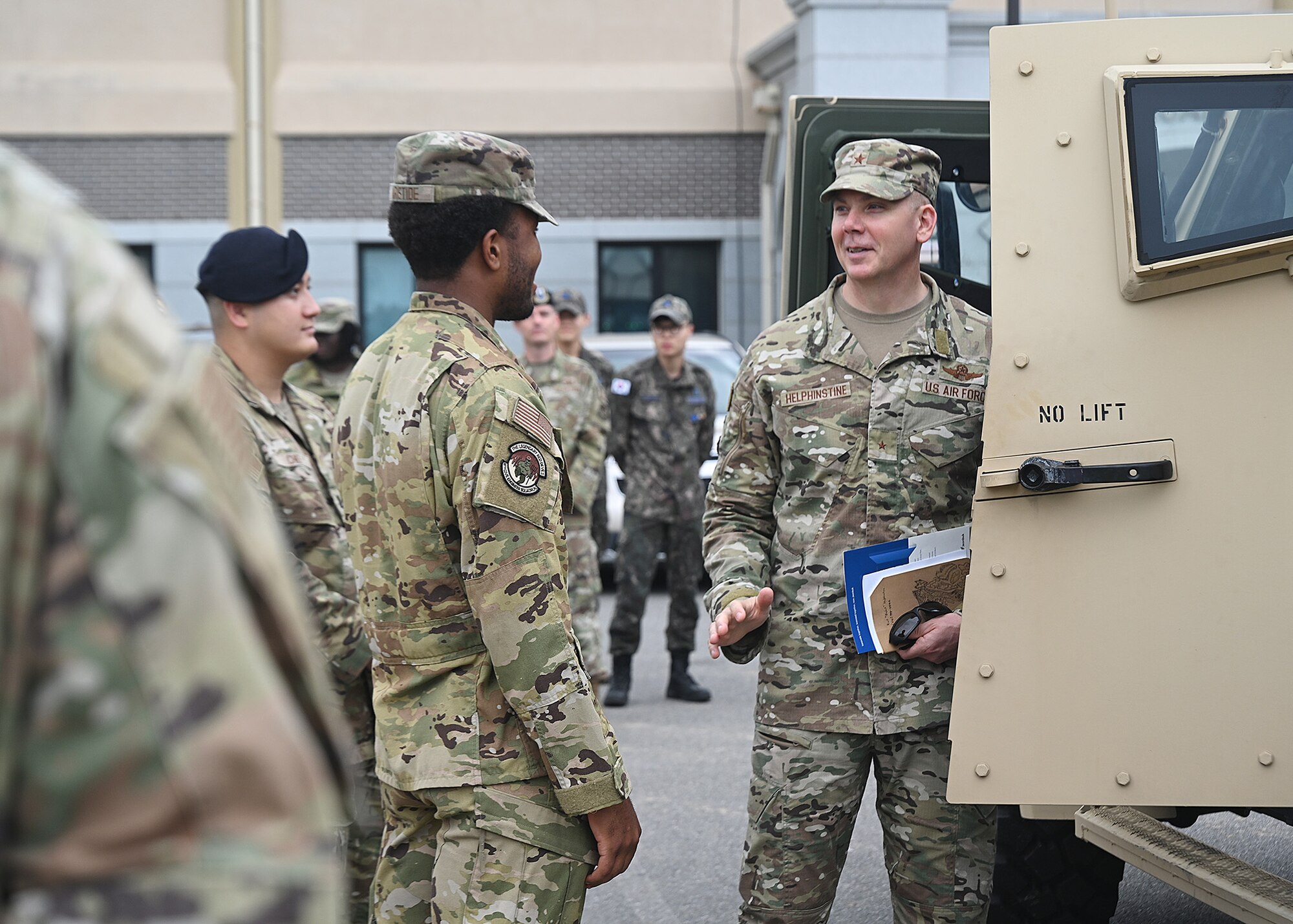 U.S. Air Force Brig. Gen. Kurt Helphinstine, 7th Air Force deputy commander, speaks with Senior Airman Johnny Aristide, 8th Civil Engineer Squadron explosive ordnance disposal technician.