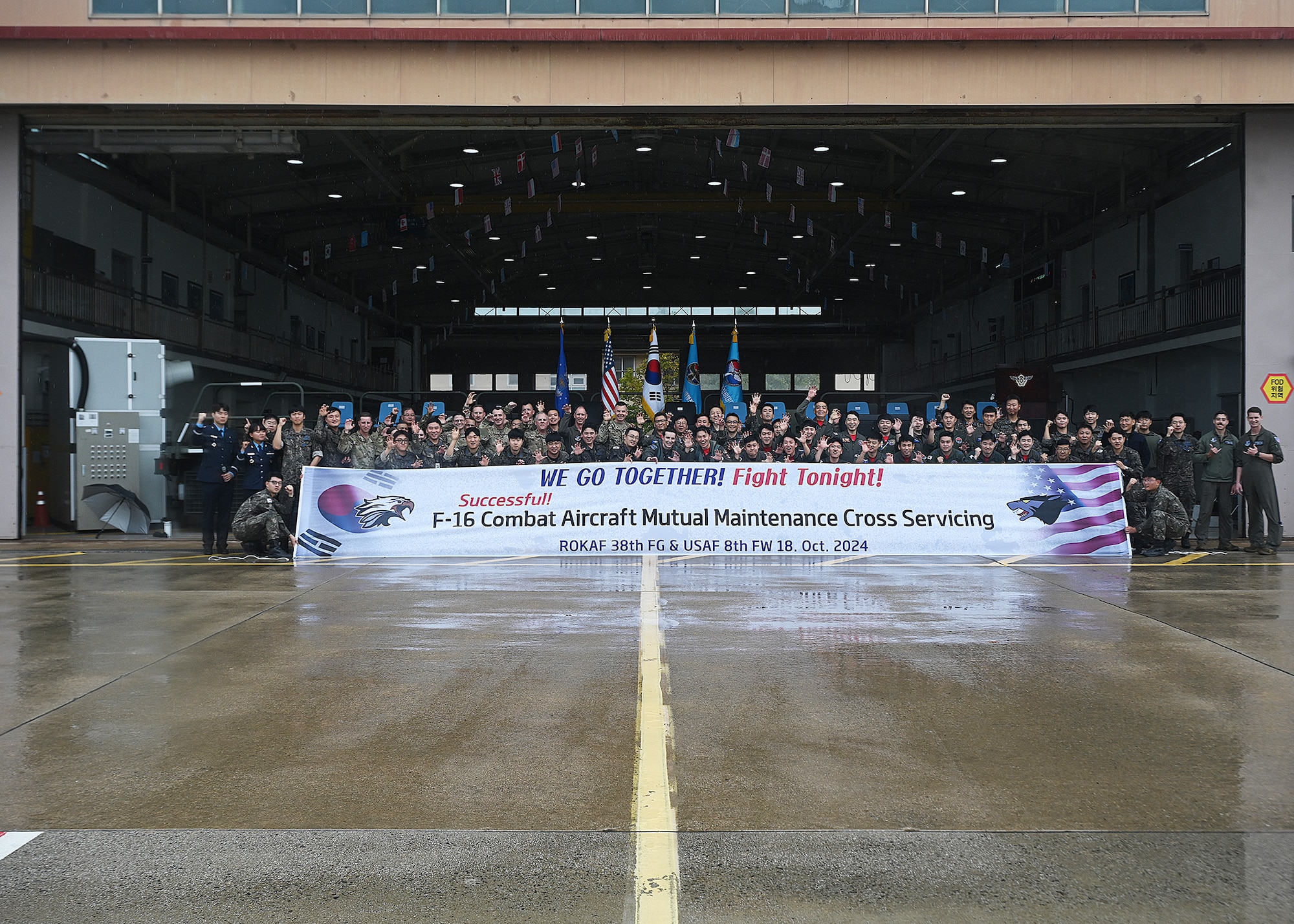 U.S. Air Force Brig. Gen. Kurt Helphinstine, 7th Air Force deputy commander, takes a photo with U.S. and Republic of Korea Airmen after the USAF - ROKAF cross servicing event.