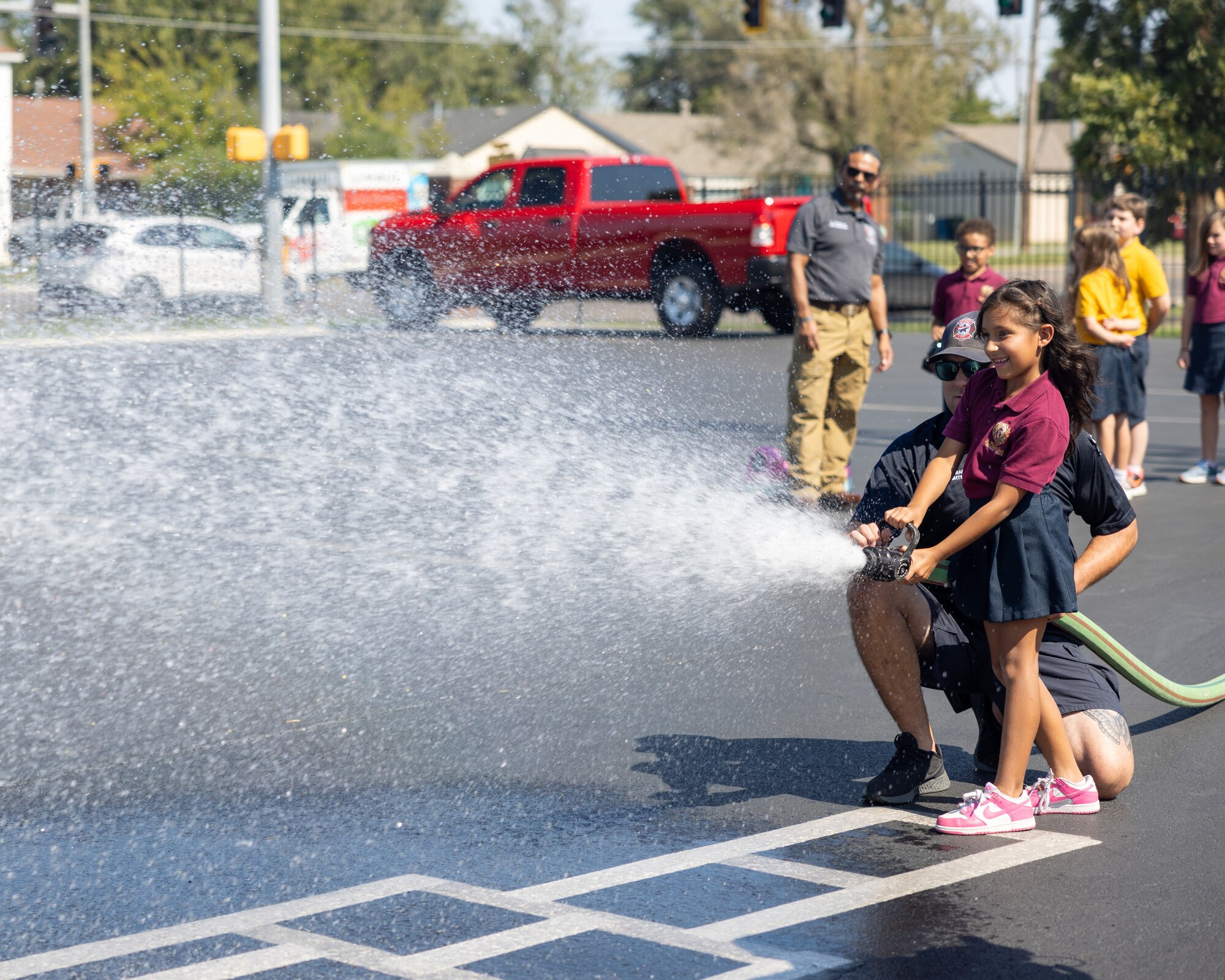 child playing with fire hose