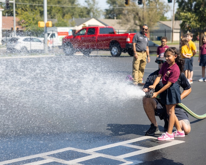 child playing with fire hose