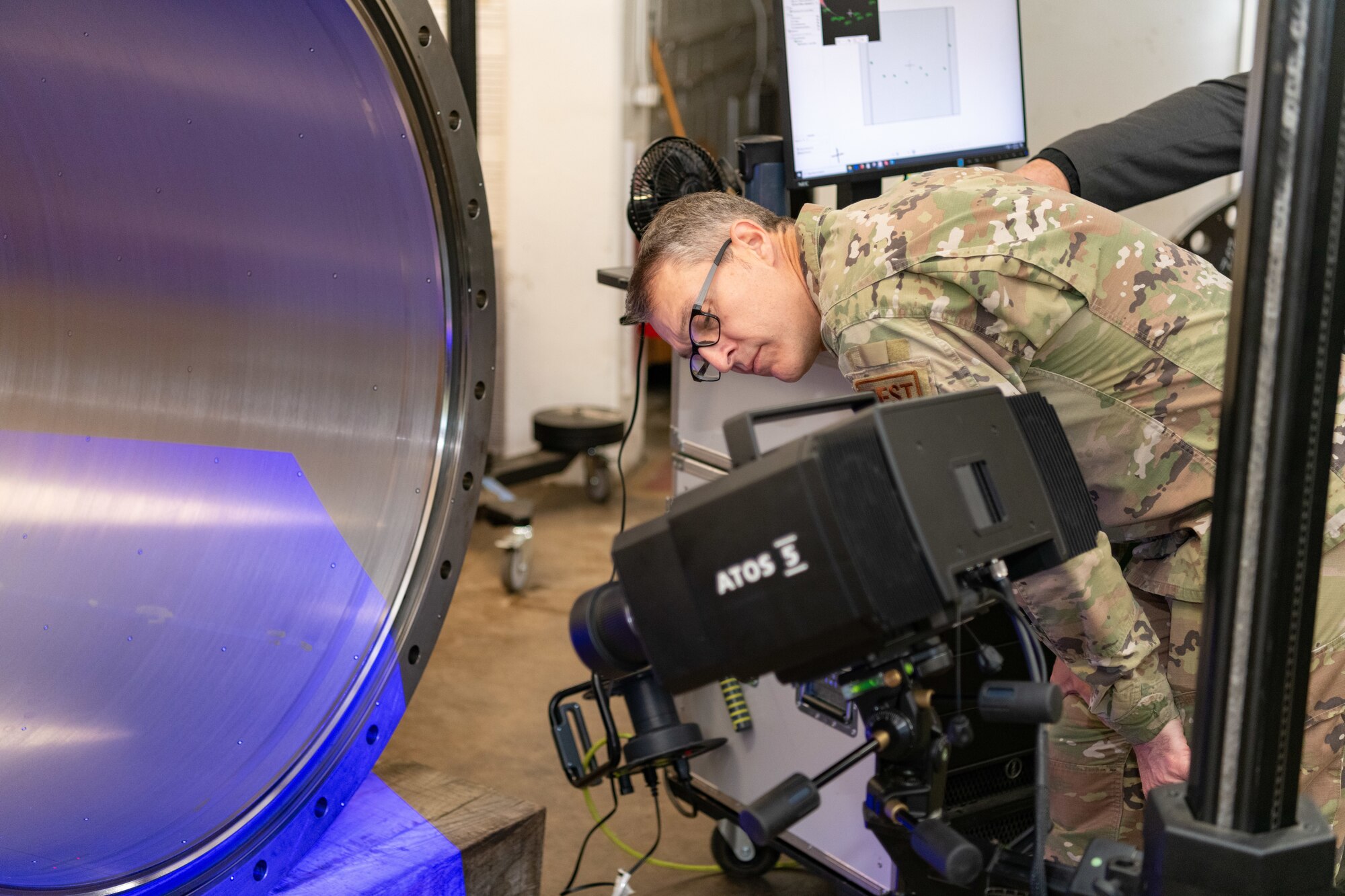 Maj. Gen. Scott A. Cain, Air Force Test Center commander, gets an up-close look at a blue light scanner used to detect dimensions of a test cell nozzle being built in the Arnold Air Force Base Model and Machine Shop during a recent visit to Arnold AFB, Tenn., headquarters of AEDC. Cain, a previous AEDC commander, visited Arnold Oct. 2-3, 2024, to tour the installation, meet with base personnel and observe operations at Arnold. (U.S. Air Force photo by Keith Thornburgh)