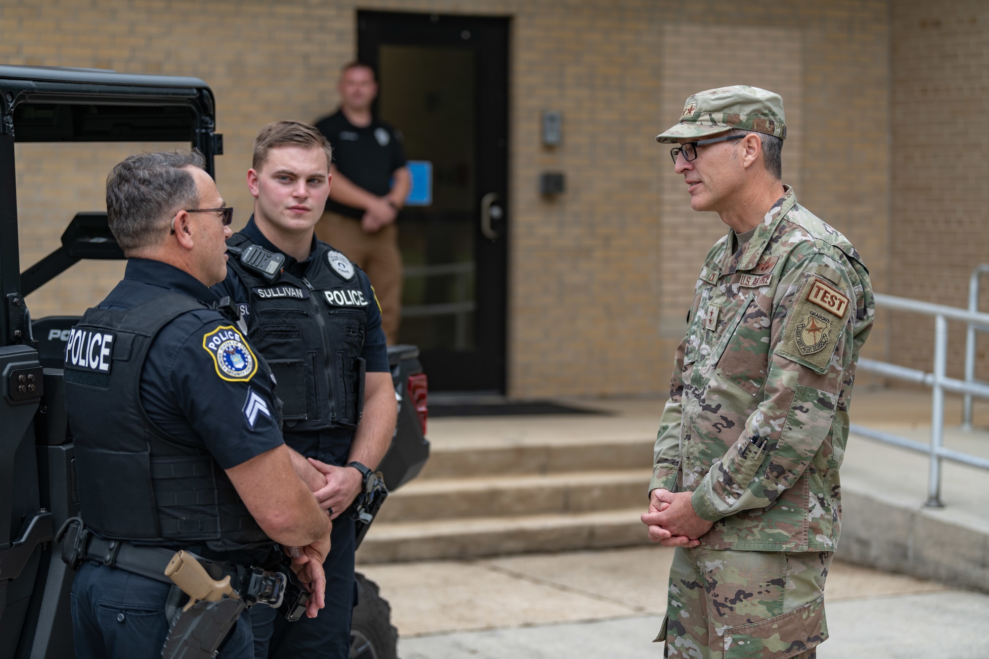 Maj. Gen. Scott A. Cain, Air Force Test Center commander, right, speaks with Cpl. James Malone, left, and Officer Byron Sullivan with Arnold Air Force Base Police during a recent visit to Arnold AFB, Tenn., headquarters of AEDC. Cain, a previous AEDC commander, visited Arnold Oct. 2-3, 2024, to tour the installation, meet with base personnel and observe operations at Arnold. (U.S. Air Force photo by Keith Thornburgh)