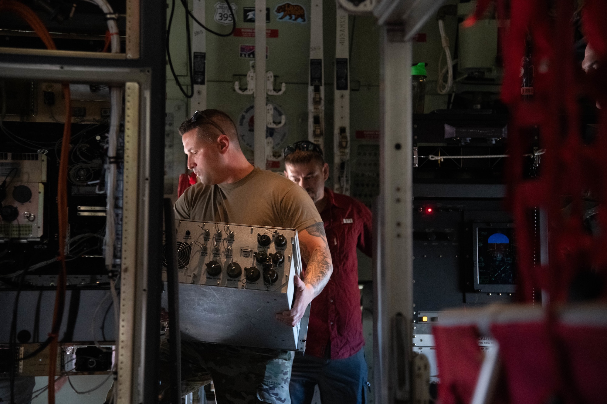 Staff Sgt. Warren Reynier installs part of the KU Antenna on a WC-130J Super Hercules.