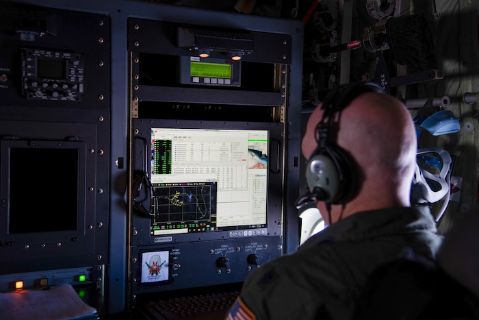 Lt. Col. Tobi Baker watches the computer during a test flight to ensure the new internet capability does not interfere with the aircraft mechanisms and software.