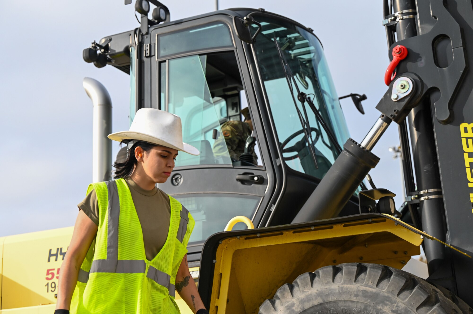 airmen directs airman driving forklift