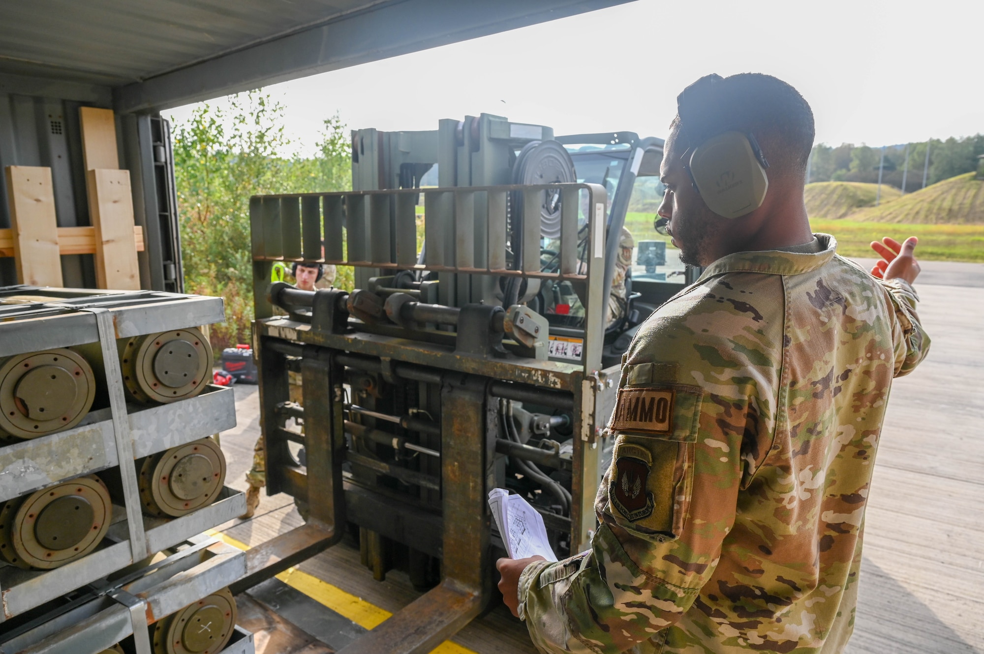 airman guides forklift driver
