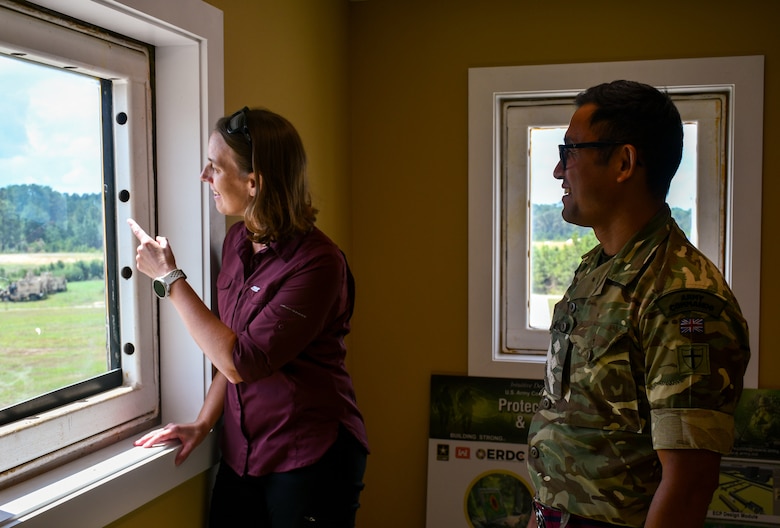 Stephanie Gates, a U.S. Army Corps of Engineers Transatlantic Middle East District structural engineer (left), and British Army Capt. Tarjan Subba, an officer with the Specialist Team Royal Engineers, a force protection engineering team from the United Kingdom (right), watch the Assessments and Solutions for Survivability from Emerging Threats live-fire demonstration at a U.S. Army Engineer Research and Development Center test range at Fort Johnson, La., Sept. 18.