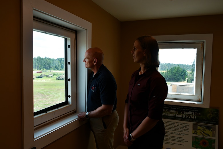 Roger Vogler, the U.S. Army Corps of Engineers Transatlantic Division engineer and construction chief (left), and Stephanie Gates, a USACE Transatlantic Middle East District structural engineer (right), watch the Assessments and Solutions for Survivability from Emerging Threats live-fire demonstration at a U.S. Army Engineer Research and Development Center test range at Fort Johnson, La., Sept. 18.