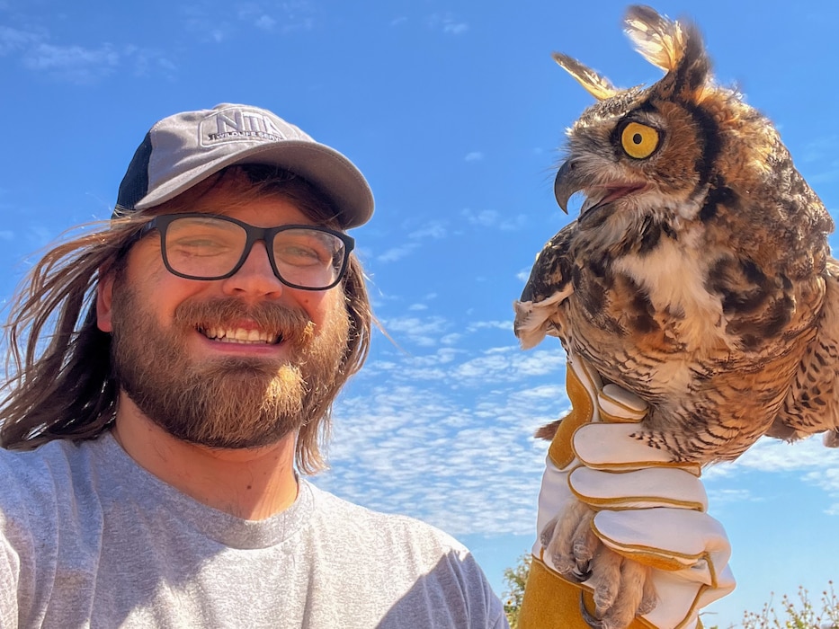 Mitchell Singer, U.S. Department of Agriculture Wildlife Services wildlife specialist, holds a great horned owl near Altus Air Force Base (AFB), Oklahoma, Sept. 2024. Singer and his team relocate migrating birds south of Altus AFB to help reduce the number of bird strikes while the birds migrate south. (Courtesy photo)