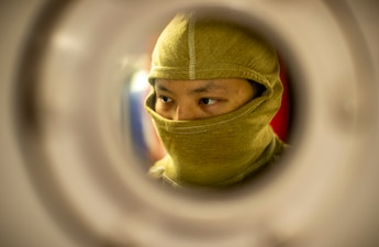 MMN2 Justin Lin closes a watertight door during a general quarters drill aboard USS George Washington (CVN 73) in the Pacific Ocean.