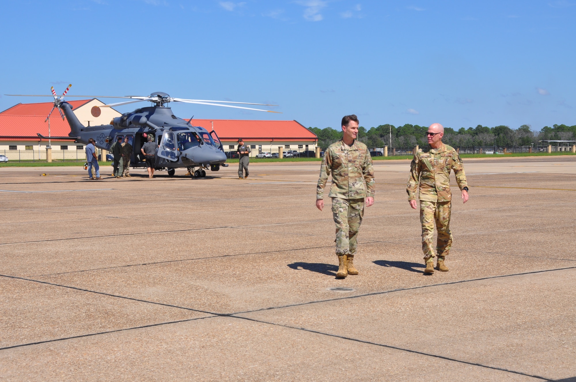 two men walk away from a helicopter