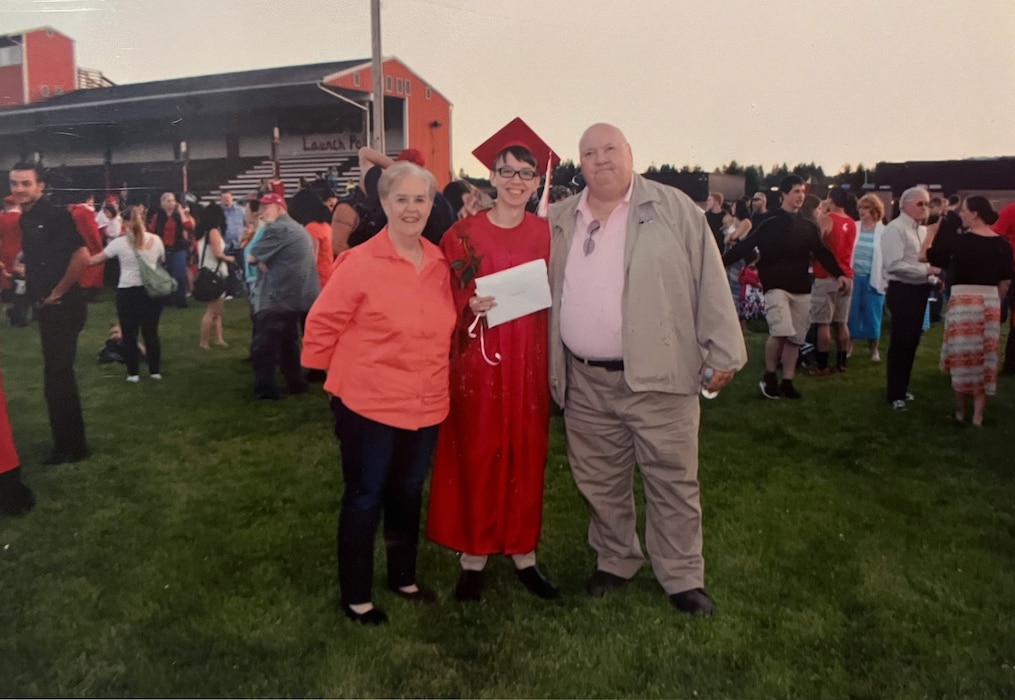 From left, Phyllis Dowell, grandmother of U.S. Air Force Staff Sgt. Cody Dowell, 97th Air Mobility Wing Public Affairs Office noncommissioned officer in charge, Cody Dowell, and Dillard Dowell, grandfather of Cody Dowell, stand together at the high school graduation of Cody Dowell, June 15, 2015, at a football field in Washington State. (complementary photo from Staff Sgt. Cody Dowell)