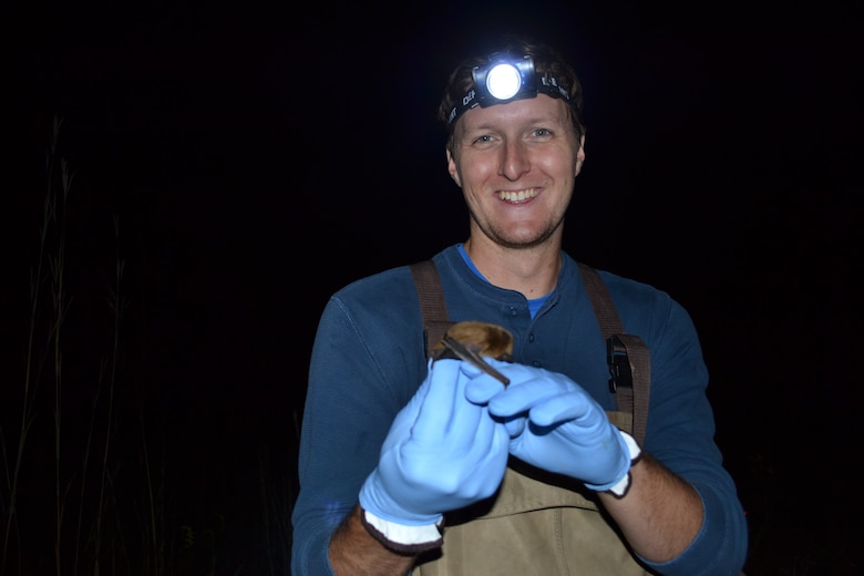 ERDC-CERL researcher Pat Wolff holding a big brown bat (Eptesicus fuscus) during a mist-net survey.
